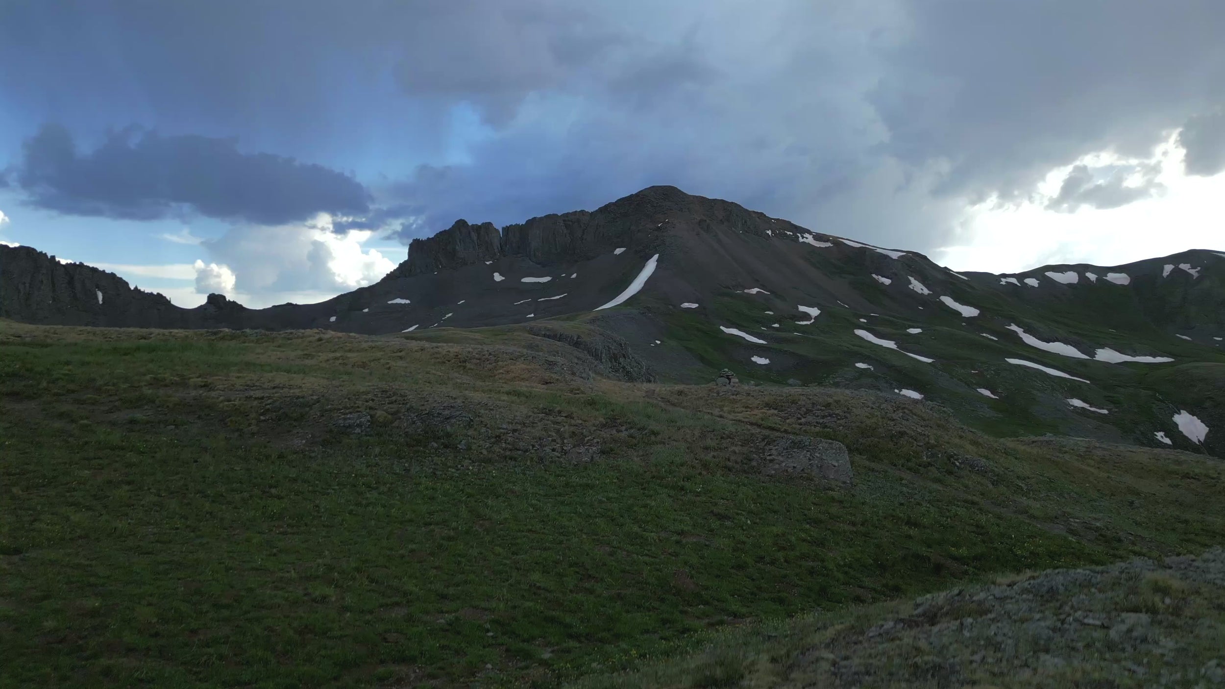 a woman backpacks in the high country of the Colorado Rocky Mountains